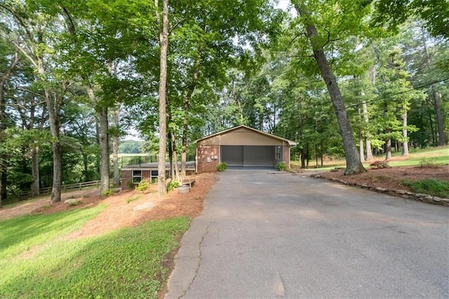 71 Seminole Trl SW, Cartersville, GA 30120 - view of front facade with driveway, a carport, brick siding, and view of wooded area