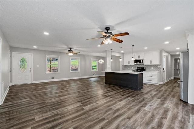 71 Seminole Trl SW, Cartersville, GA 30120 - kitchen with appliances with stainless steel finishes, open floor plan, a center island, a ceiling fan, and white cabinetry