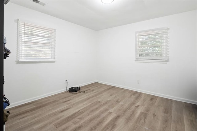 empty room with light hardwood / wood-style floors