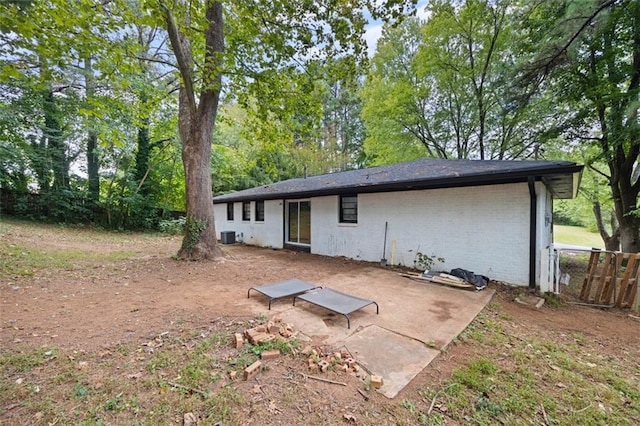 back of house with central AC unit