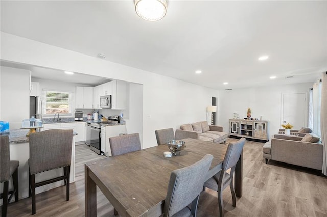 dining room featuring light hardwood / wood-style flooring and sink