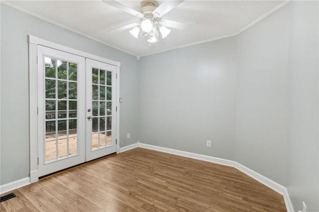 spare room featuring crown molding, light hardwood / wood-style floors, ceiling fan, and french doors