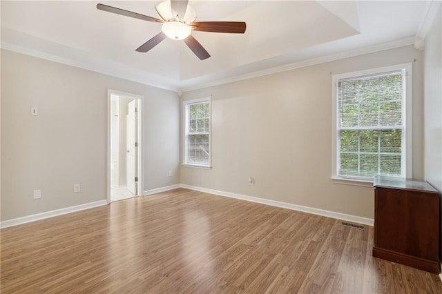 empty room with ceiling fan, light wood-type flooring, and plenty of natural light