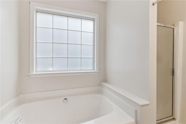 bathroom featuring separate shower and tub