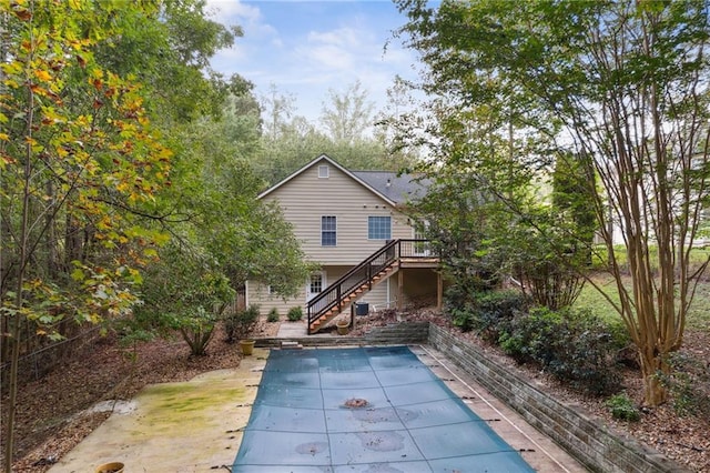 178 Seals Dr, Dallas, GA 30157 - back of property with a covered pool, a patio area, a deck, and stairway