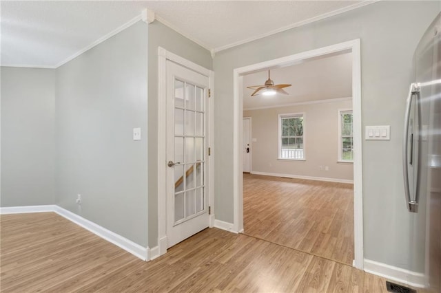 hall with light wood-type flooring and crown molding