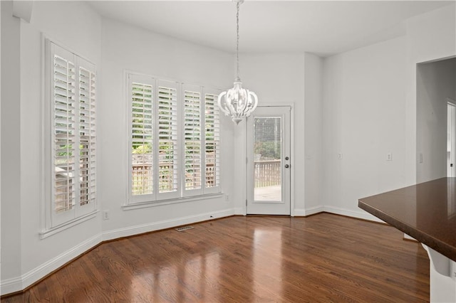 5725 Lake Oak Lndg, Cumming, GA 30040 - unfurnished dining area featuring a chandelier, dark wood-style flooring, healthy amount of natural light, and baseboards