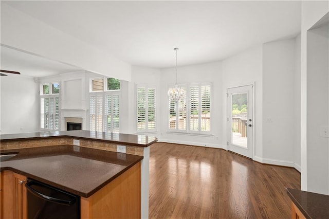 5725 Lake Oak Lndg, Cumming, GA 30040 - kitchen with open floor plan, a chandelier, wood finished floors, a fireplace, and dishwasher