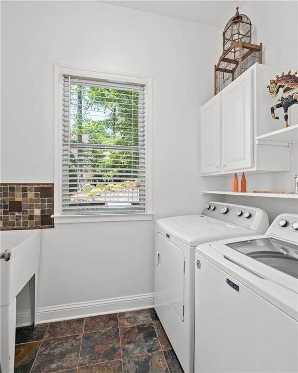 5725 Lake Oak Lndg, Cumming, GA 30040 - laundry room featuring washing machine and clothes dryer, cabinet space, dark stone finish flooring, and baseboards
