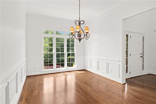 5725 Lake Oak Lndg, Cumming, GA 30040 - unfurnished dining area with a chandelier, crown molding, wood finished floors, wainscoting, and a decorative wall