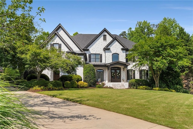 view of front facade with french doors and a front lawn