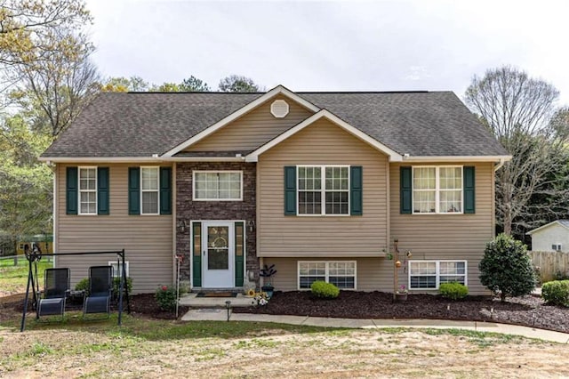 split foyer home featuring a front lawn