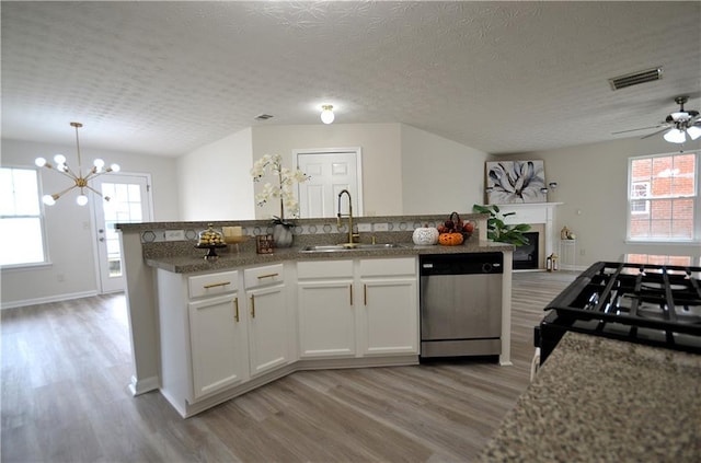 kitchen with sink, dishwasher, white cabinets, and plenty of natural light