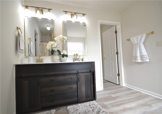 bathroom featuring vanity and hardwood / wood-style flooring