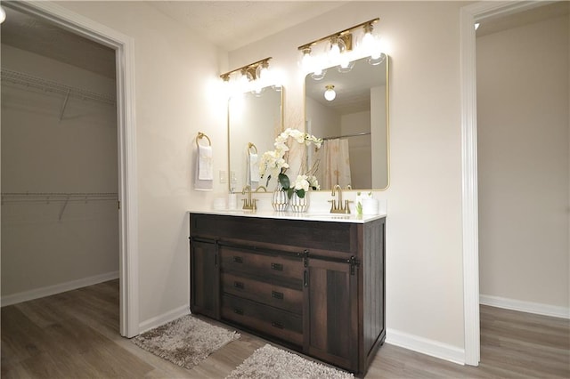 bathroom featuring vanity and hardwood / wood-style floors