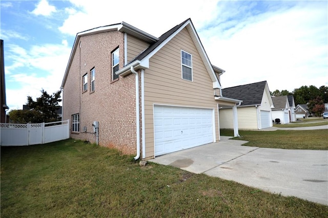 view of side of property with a yard and a garage