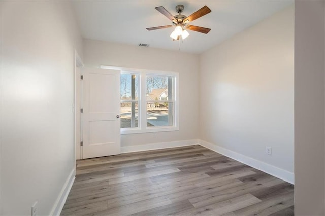 unfurnished room with hardwood / wood-style floors and ceiling fan