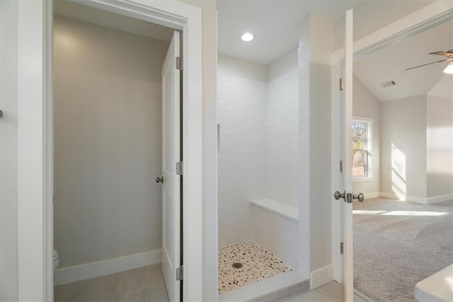 bathroom with ceiling fan, a shower, vaulted ceiling, and toilet