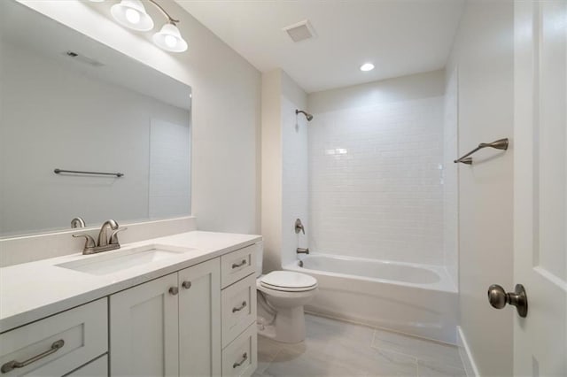 full bathroom with vanity, tiled shower / bath combo, and toilet