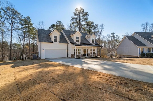 cape cod home with cooling unit and a garage