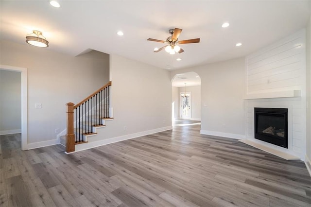 unfurnished living room with ceiling fan and hardwood / wood-style flooring