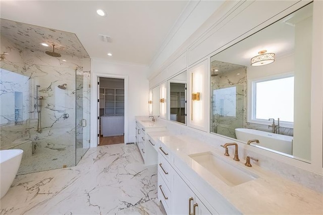full bathroom featuring a marble finish shower, crown molding, vanity, a freestanding tub, and recessed lighting