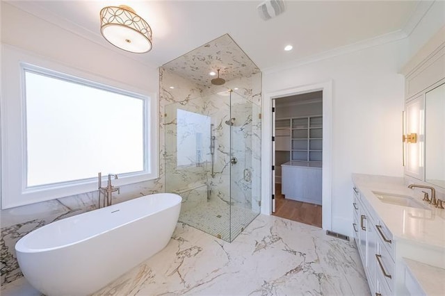 bathroom featuring a marble finish shower, a soaking tub, a spacious closet, vanity, and marble tiled flooring