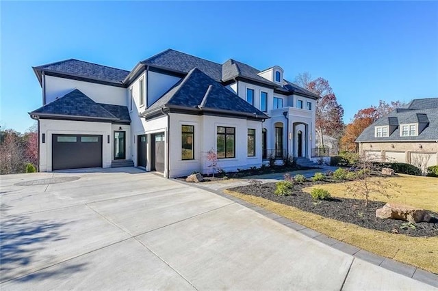 view of front of property with concrete driveway, stucco siding, and a garage