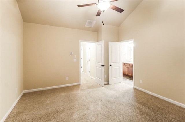 unfurnished bedroom featuring visible vents, ensuite bathroom, baseboards, and light carpet