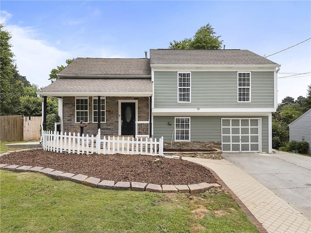 1491 Black Hickory Pl, Norcross, GA 30093 - split level home with concrete driveway, a porch, an attached garage, and roof with shingles