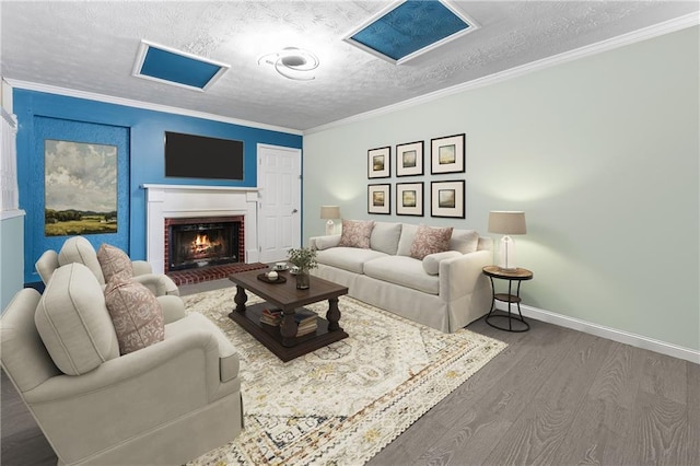1491 Black Hickory Pl, Norcross, GA 30093 - living room featuring wood finished floors, baseboards, a textured ceiling, crown molding, and a fireplace