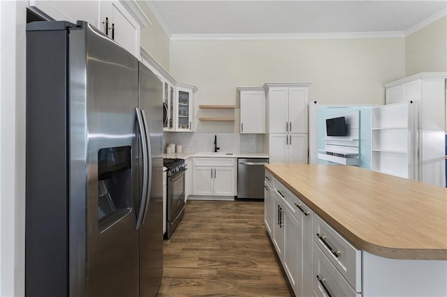 1491 Black Hickory Pl, Norcross, GA 30093 - kitchen with appliances with stainless steel finishes, crown molding, a sink, open shelves, and backsplash
