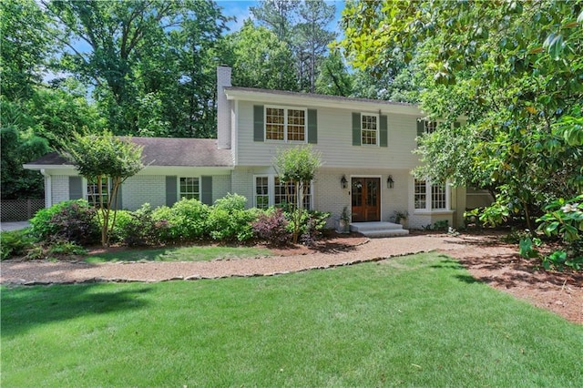 435 Grenock Cir, Atlanta, GA 30328 - colonial house with brick siding, a front yard, a chimney, and french doors