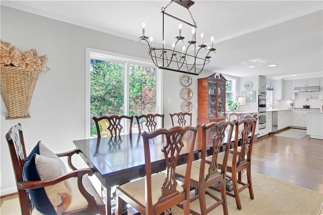 435 Grenock Cir, Atlanta, GA 30328 - dining area with a chandelier, light wood-style flooring, crown molding, and recessed lighting