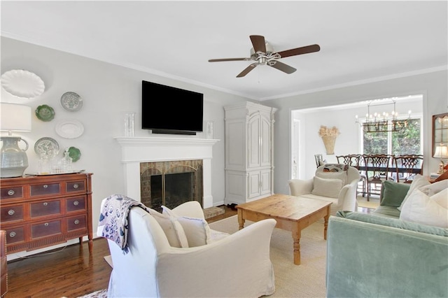 435 Grenock Cir, Atlanta, GA 30328 - living room featuring a ceiling fan, ornamental molding, wood finished floors, a tile fireplace, and a chandelier