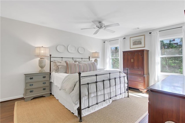 435 Grenock Cir, Atlanta, GA 30328 - bedroom featuring multiple windows, wood finished floors, baseboards, and a ceiling fan