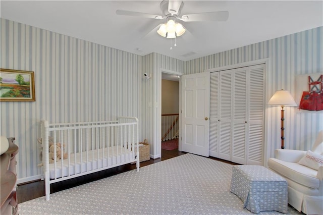 435 Grenock Cir, Atlanta, GA 30328 - bedroom with wallpapered walls, a closet, wood finished floors, and ceiling fan