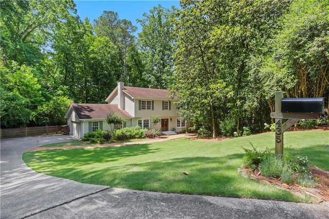 435 Grenock Cir, Atlanta, GA 30328 - view of front of house with asphalt driveway, an attached garage, a front yard, and a chimney