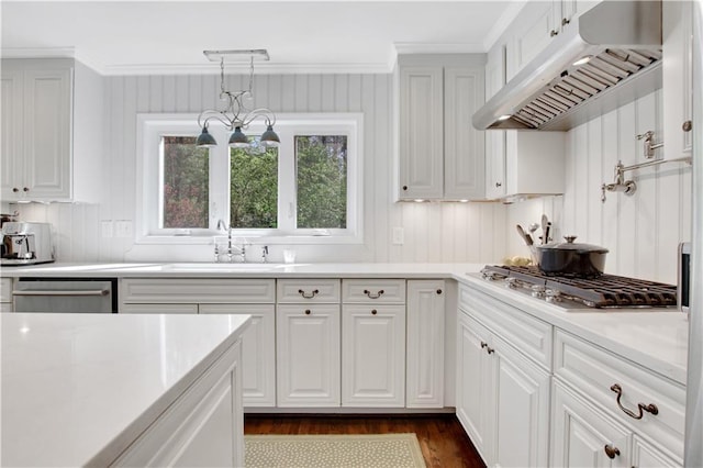 435 Grenock Cir, Atlanta, GA 30328 - kitchen featuring under cabinet range hood, appliances with stainless steel finishes, light countertops, dark wood finished floors, and ornamental molding