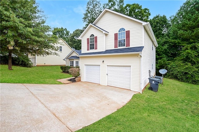 view of side of property with a lawn and a garage