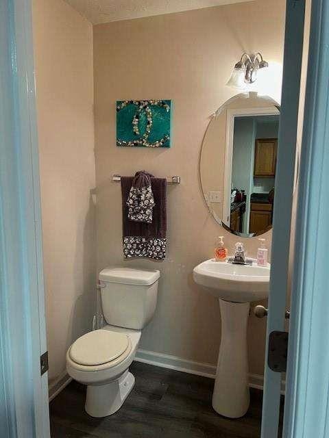 bathroom featuring sink, hardwood / wood-style flooring, and toilet