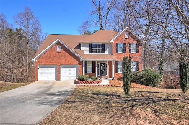 view of front facade featuring a garage, driveway, and brick siding