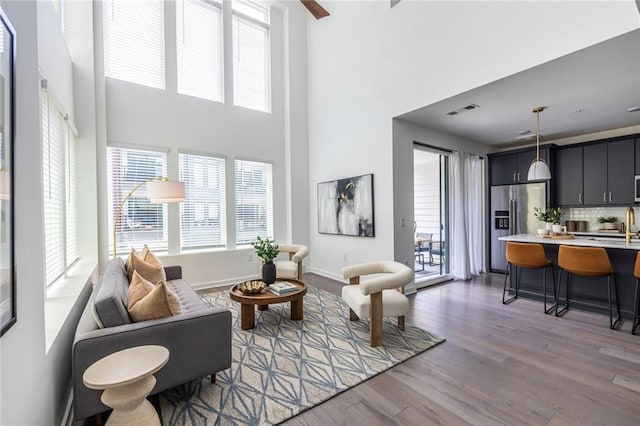 399 Pratt Dr SE, Atlanta, GA 30315 - living area featuring wood finished floors, a high ceiling, and baseboards