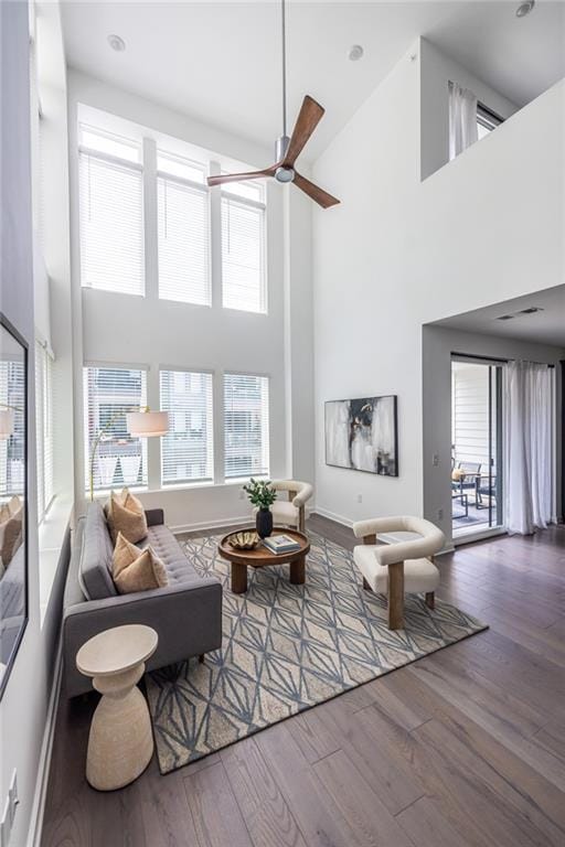 399 Pratt Dr SE, Atlanta, GA 30315 - living area featuring a towering ceiling, ceiling fan, wood finished floors, and baseboards