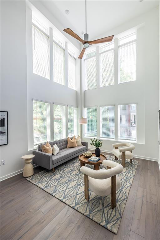 399 Pratt Dr SE, Atlanta, GA 30315 - living room with a high ceiling, wood-type flooring, ceiling fan, and baseboards