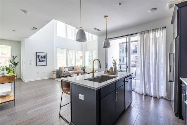 399 Pratt Dr SE, Atlanta, GA 30315 - kitchen featuring a sink, open floor plan, dark wood-style flooring, an island with sink, and light countertops