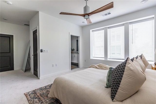 399 Pratt Dr SE, Atlanta, GA 30315 - carpeted bedroom with multiple windows, baseboards, ceiling fan, and ensuite bathroom