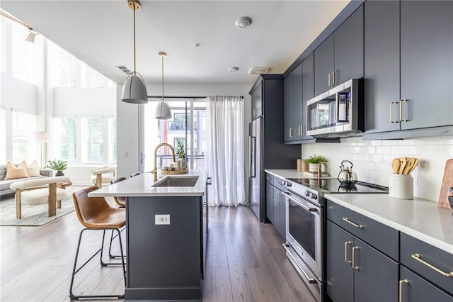 399 Pratt Dr SE, Atlanta, GA 30315 - kitchen featuring appliances with stainless steel finishes, a sink, light countertops, and open floor plan