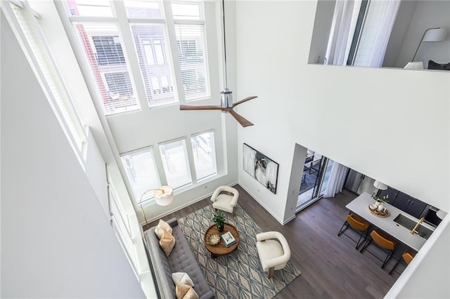 399 Pratt Dr SE, Atlanta, GA 30315 - living room with plenty of natural light, a high ceiling, wood finished floors, ceiling fan, and baseboards
