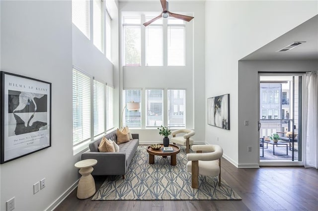 399 Pratt Dr SE, Atlanta, GA 30315 - living room featuring a towering ceiling, a ceiling fan, wood finished floors, and baseboards